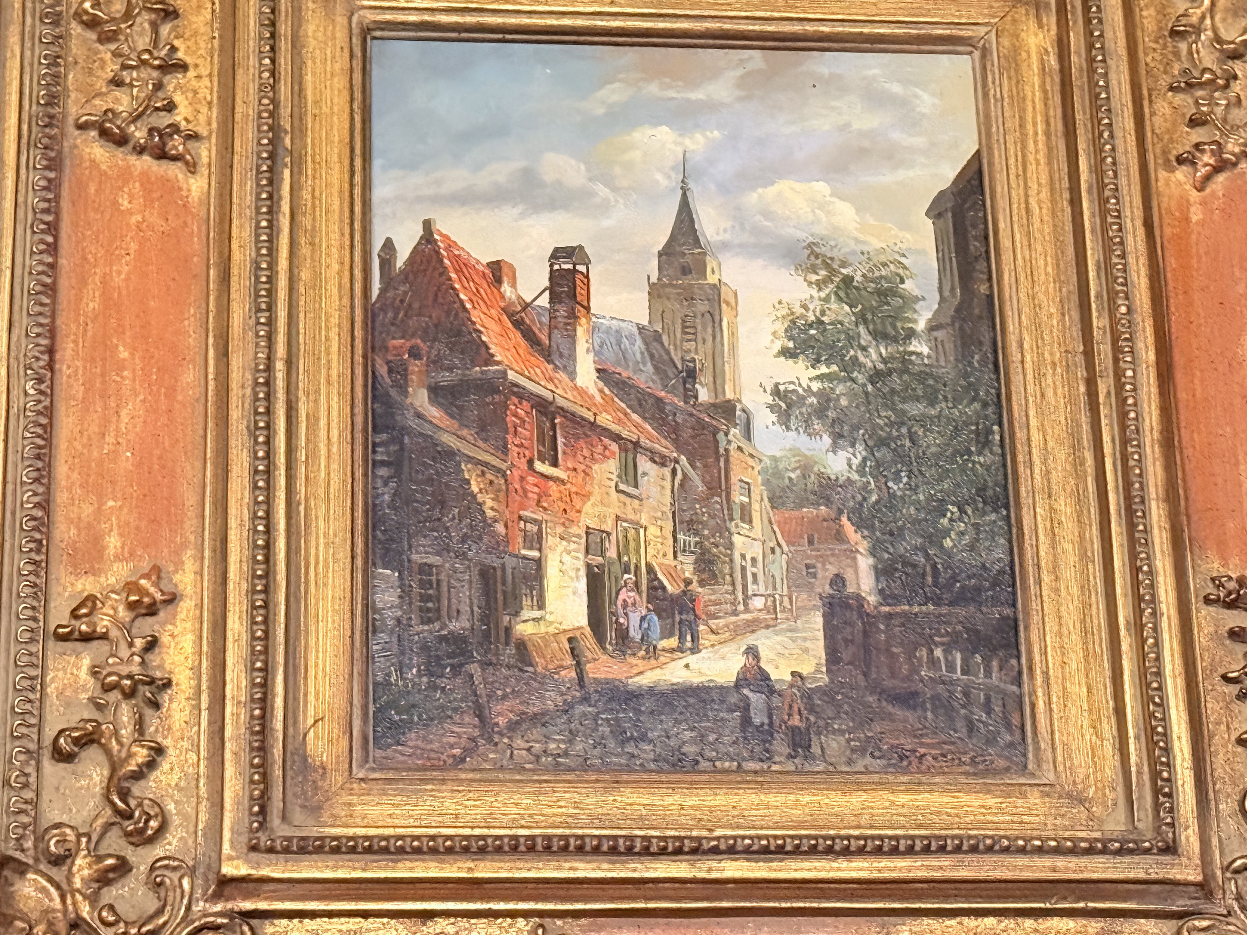 Painting of an old European street with a church spire.