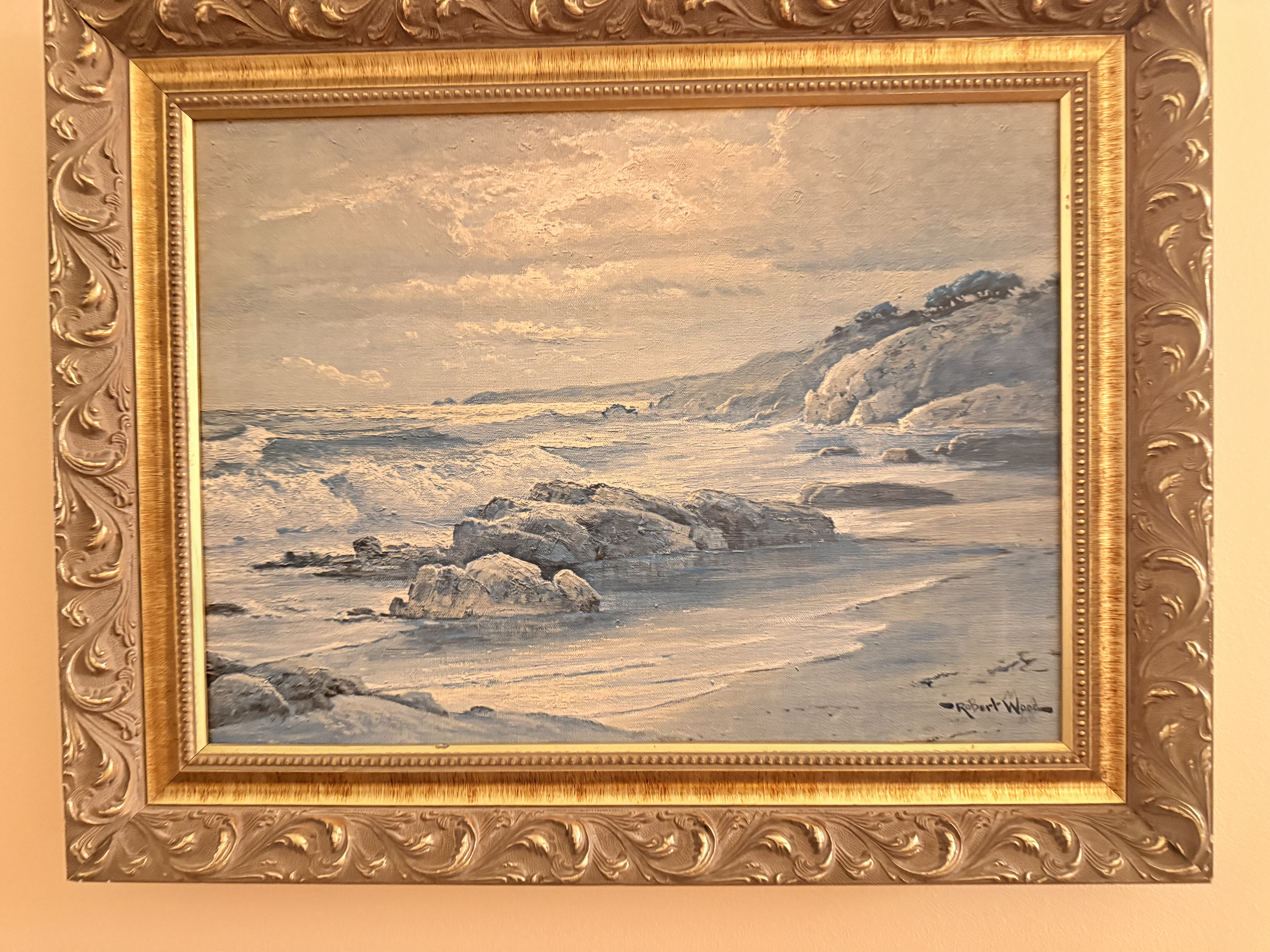 Seascape painting of waves breaking on rocks.