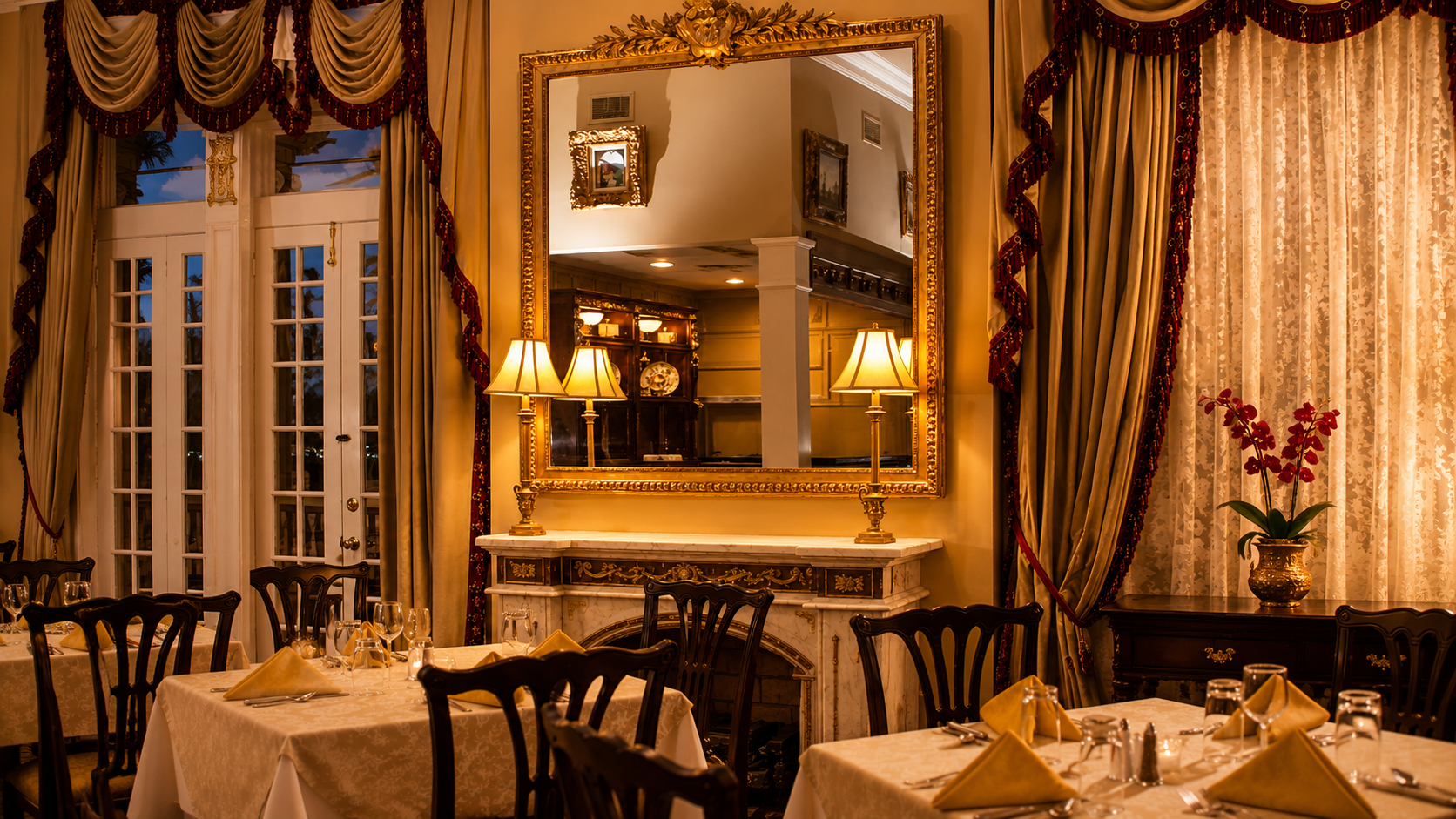 Candlelit dinner table set inside the mansion.