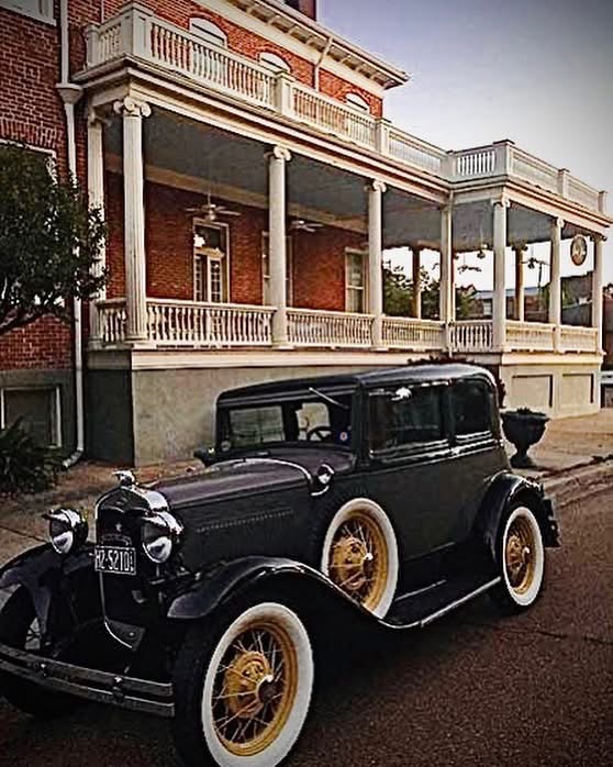 A vintage motorcar parked in front of The Guest House.